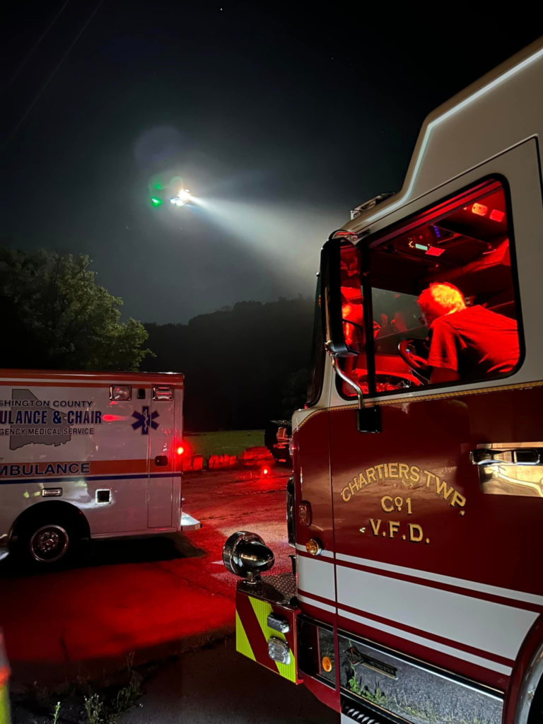A firefighter from Chartiers Township Volunteer Fire Department sits in the driver's seat of a firetruck as he helps facilitate an emergency helicopter landing.